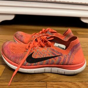 Nike Women’s Orange Flyknit Running Sneakers women’s 6